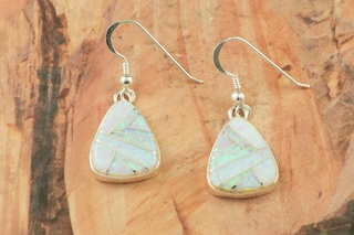 Stunning Fire and Ice Lab Opals inlaid between ribbons of Sterling Silver. Beautiful Sterling Silver French Wire Earrings feature precision channel inlay. Designed by Navajo Artist Calvin Begay. Signed.